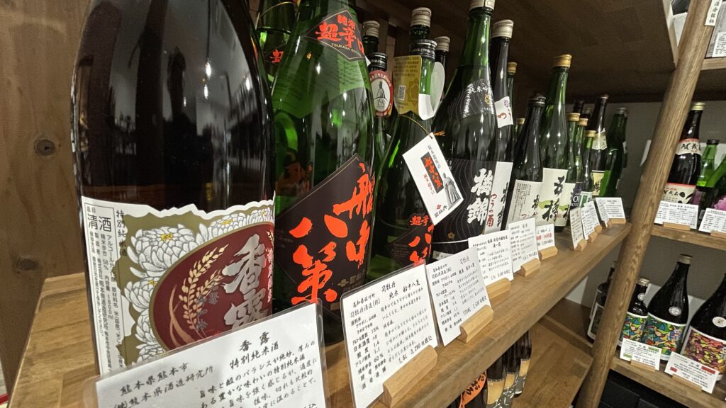 Close-up of premium sake bottles with tasting notes at Ito Sake Shop
