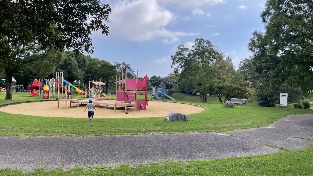 Panoramic view of Hyakkadai Park playground area with slides and climbing equipment