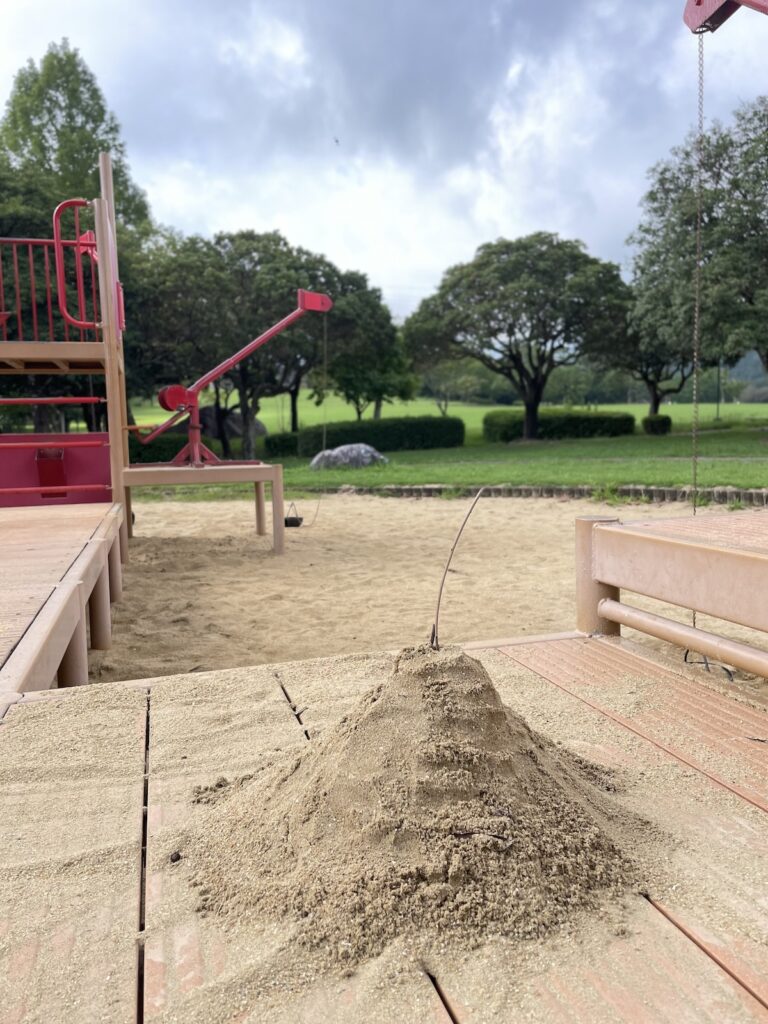 Sand play area at Hyakkadai Park with children building sand structures