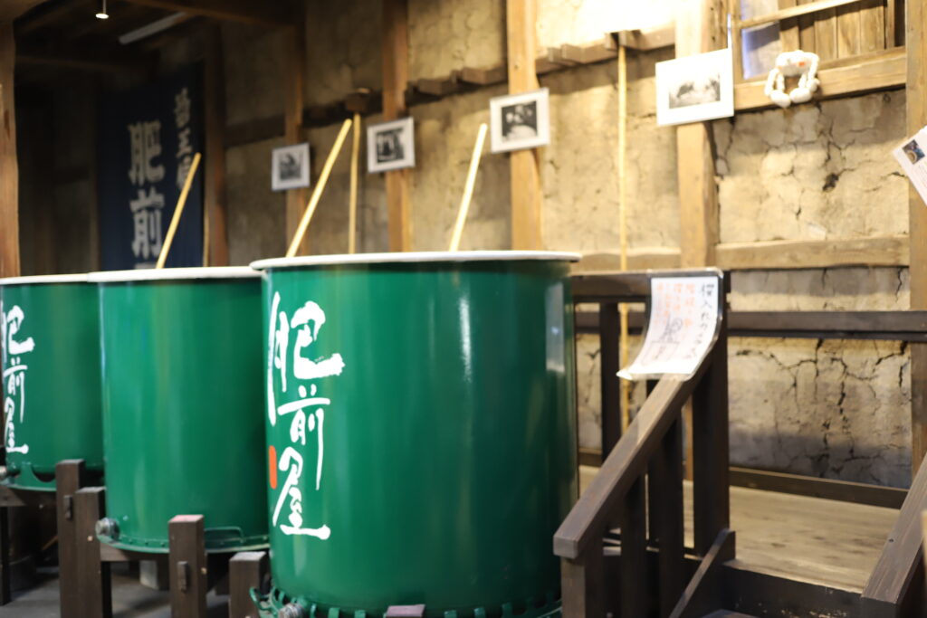Traditional sake brewing tanks on display inside Mitsutake Sake Brewery in Kashima, Saga.