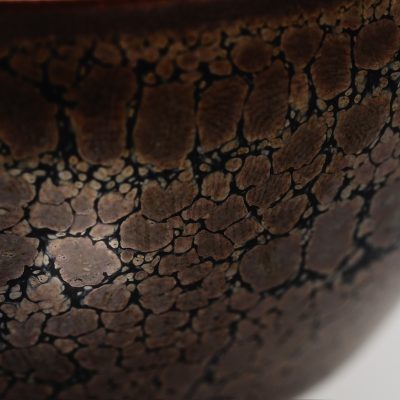 Close-up of an Arita porcelain piece from Shinemon Kiln, featuring a unique glaze pattern resembling natural stone textures.